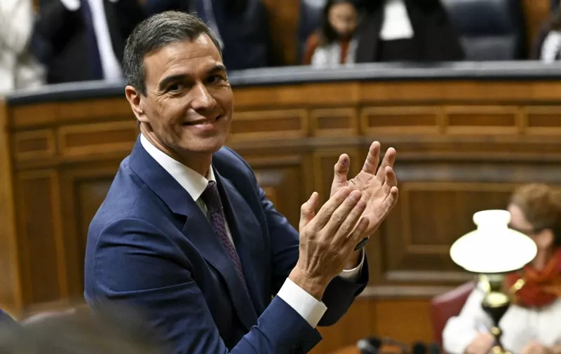 Spain's acting Prime Minister Pedro Sanchez applauds during a parliamentary debate ahead of a vote to elect Spain's next premier, at the Congress of Deputies in Madrid on November 16, 2023. Pedro Sanchez is poised to win today the backing of Spain's parliament for another term as prime minister, with the country divided over his decision to grant Catalan separatists an amnesty in exchange for their crucial support in a vote of confidence. (Photo by JAVIER SORIANO / AFP)