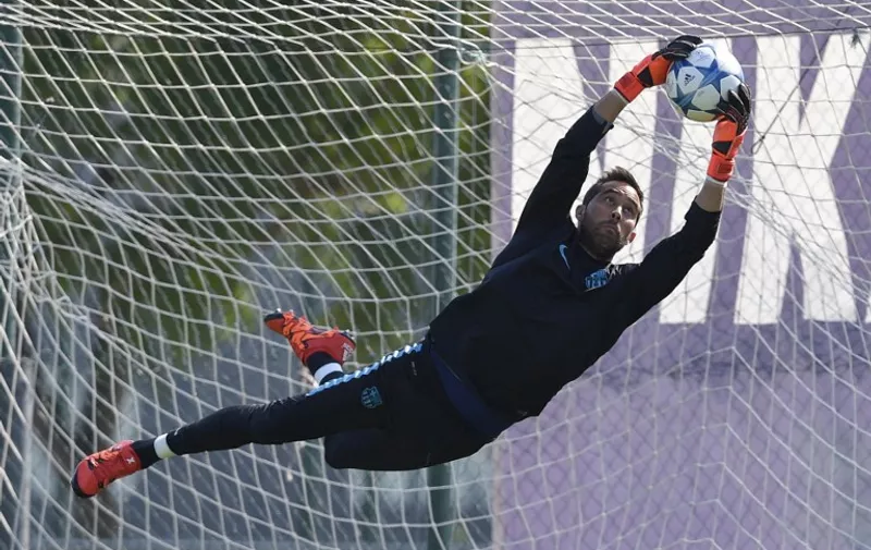 Barcelona's Chilean goalkeeper Claudio Bravo jumps for a ball during a training session at the Sports Center FC Barcelona Joan Gamper in Sant Joan Despi, near Barcelona on September 28, 2015, on the eve of the UEFA Champions League Group E football match between FC Barcelona and Bayer Leverkusen. AFP PHOTO / LLUIS GENE