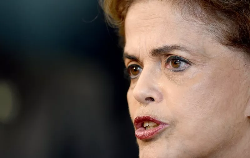 Brazilian President Dilma Rousseff holds a meeting with rectors of public universities and technical education at Planalto Palace in Brasilia, on March 11, 2016. Brazilian President Dilma Rousseff dug in Friday amid a swirling political crisis, insisting she would not resign and adamantly backing her embattled predecessor, Luiz Inacio Lula da Silva. With money-laundering charges against Lula adding to the pressure on her administration, Rousseff rejected calls to stand down, vehemently defended her mentor and said she would even be proud to have him in her cabinet -- a move that could used to protect the ex-president. Rousseff is facing an impeachment drive, a bruising recession, a massive scandal at state oil company Petrobras and a probe into alleged violations of electoral law in her reelection campaign last year.   AFP PHOTO / EVARISTO SA / AFP PHOTO / EVARISTO SA