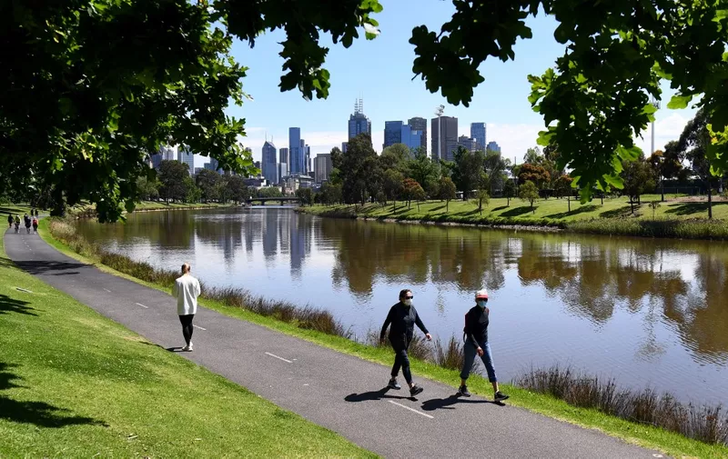 People enjoy the spring weather along the banks of Melbourne's Yarra River on October 16, 2020, as Australia's Victoria state records only two new COVID-19 coronavirus cases and no deaths, the lowest daily figure since June 9. (Photo by William WEST / AFP)