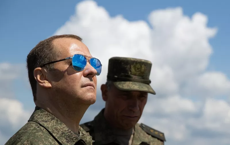 Russia's former president and now serving as deputy chairman of the country's Security Council, Dmitry Medvedev (L), visits the Totsky military training field outside Siberian city of Orenburg on July 14, 2023. (Photo by Yekaterina SHTUKINA / SPUTNIK / AFP)