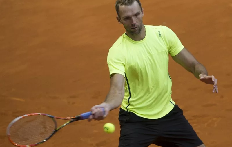 Croatian tennis player Ivo Karlovic returns a ball to French tennis player Richard Gasquet during day four of the Madrid Open tournament at the Caja Magica (Magic Box) sports complex in Madrid on May 5, 2015.  AFP PHOTO
