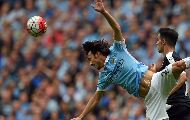 Manchester City's Spanish midfielder David Silva jumps for the ball during the English Premier League football match between Manchester City and Watford at The Etihad Stadium in Manchester, north west England on August 29, 2015. Manchester City won the game 2-0. AFP PHOTO / PAUL ELLIS

RESTRICTED TO EDITORIAL USE. No use with unauthorized audio, video, data, fixture lists, club/league logos or 'live' services. Online in-match use limited to 75 images, no video emulation. No use in betting, games or single club/league/player publications.