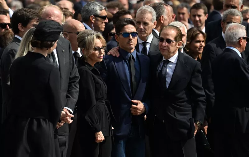 (From L) The daughter of late Italian former Prime Minister and media mogul Silvio Berlusconi, Marina Berlusconi, his son Pier Silvio Berlusconi and brother Paolo Berlusconi unite as they leave the Duomo cathedral in Milan on June 14, 2023 following the state funeral of Berlusconi. (Photo by Andreas SOLARO / AFP)
