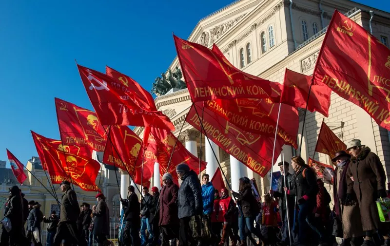 People hold red flags during a rally to mark the 98th anniversary of Russia's Bolshevik Revolution in central Moscow on November 7, 2015.  AFP PHOTO / DMITRY SEREBRYAKOV