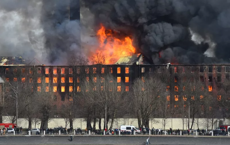 Smoke and flames rise from a burning historic factory in Saint Petersburg on April 12, 2021. (Photo by Olga MALTSEVA / AFP)