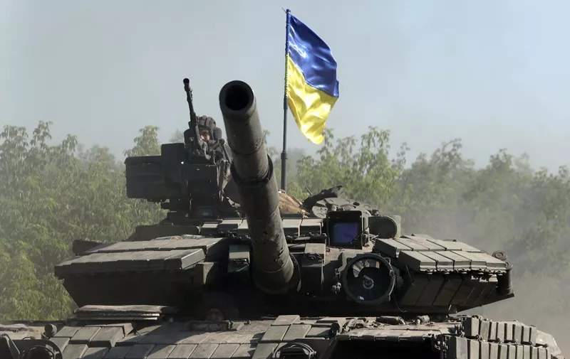 Ukrainian troop ride a tank on a road of the eastern Ukrainian region of Donbas on June 21, 2022, as Ukraine says Russian shelling has caused "catastrophic destruction" in the eastern industrial city of Lysychansk, which lies just across a river from Severodonetsk where Russian and Ukrainian troops have been locked in battle for weeks. - Regional governor Sergiy Gaiday says that non-stop shelling of Lysychansk on June 20 destroyed 10 residential blocks and a police station, killing at least one person. (Photo by Anatolii Stepanov / AFP)