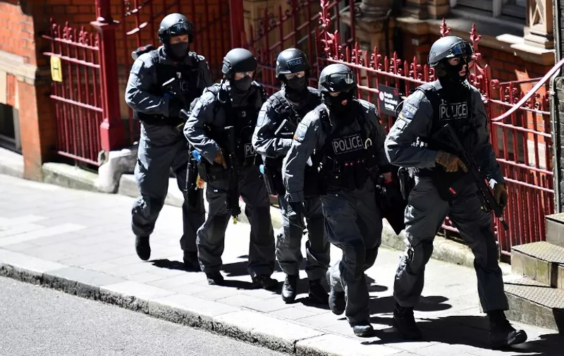 Members of the police walk as they take part in exercise Strong Tower, a counter-terror exercise held in and around the disused London Underground station at Aldwych in central London on June 30, 2015. British police today launched a major counter-terror exercise in London partly influenced by the Charlie Hebdo attacks in Paris in January, just days after an Islamist gun massacre in Tunisia. 
AFP PHOTO / BEN STANSALL