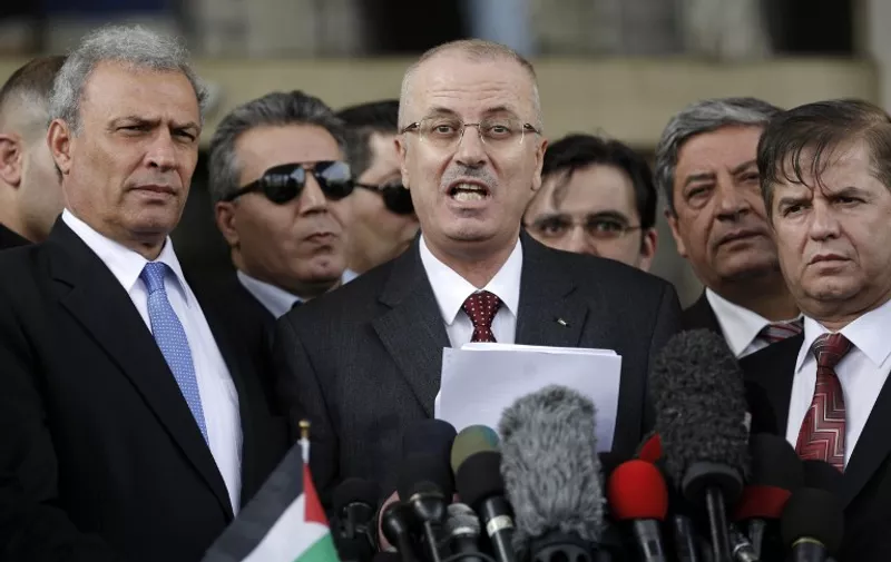 Palestinian prime minister Rami Hamdallah speaks during a press conference in Gaza City on March 25, 2015 during a visit in the Palestinian coastal territory. Hamdallah urged rival factions to set aside their differences, even as protesters gave him a cool reception in war-battered Gaza . AFP PHOTO / MOHAMMED ABED