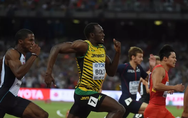 Jamaica's Usain Bolt (C) and China's Su Bingtian (R) compete in the semi-final of the men's 100 metres athletics event at the 2015 IAAF World Championships at the "Bird's Nest" National Stadium in Beijing on August 23, 2015.  