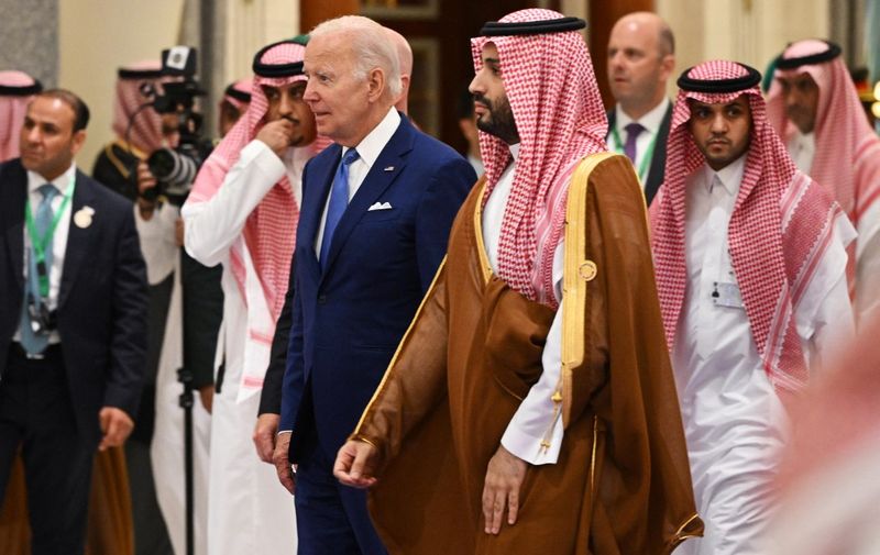 US President Joe Biden (L) and Saudi Crown Prince Mohammed bin Salman (R) arrive for the family photo during the Jeddah Security and Development Summit (GCC+3) at a hotel in Saudi Arabia's Red Sea coastal city of Jeddah on July 16, 2022. (Photo by MANDEL NGAN / POOL / AFP)