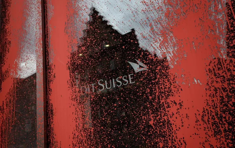 A picture taken on May 15, 2020 in Basel, shows a window of a Swiss bank Credit Suisse branch smeared with red paint by unknown persons. - Credit Suisse has been targeted several times by climate activists' actions to stop investing in fossil fuels. (Photo by Fabrice COFFRINI / AFP)