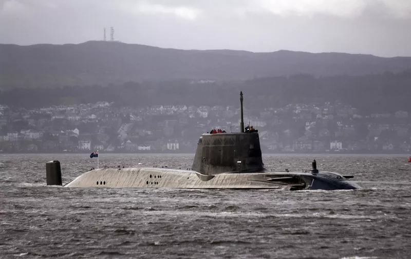 HMS Astute, the British Royal Navy's latest nuclear hunter killer submarine, sails up Gareloch on the Firth of Cylde to her new base at Faslane, in western Scotland, on November 20, 2009. Astute is armed with 38 torpedoes and missiles, and is able to circumnavigate the globe without refuelling due to the nuclear technology used. AFP PHOTO/Andy Buchanan (Photo by Andy Buchanan / AFP)
