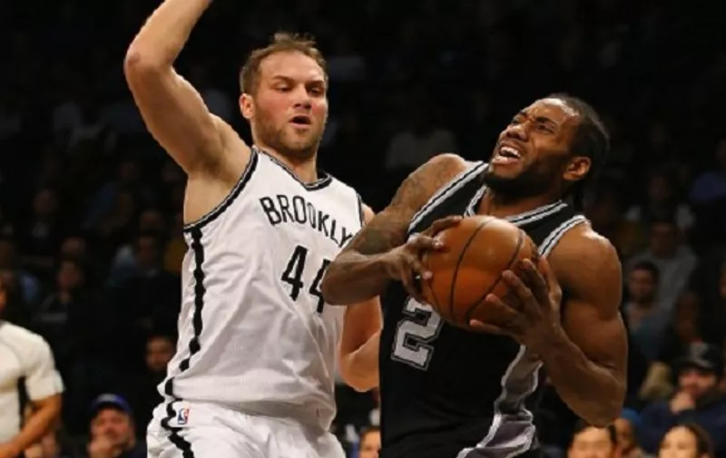 NEW YORK, NY - JANUARY 11: Kawhi Leonard #2 of the San Antonio Spurs drives against Bojan Bogdanovic #44 of the Brooklyn Nets during their game at the Barclays Center on January 11, 2016 in New York City. NOTE TO USER: User expressly acknowledges and agrees that, by downloading and/or using this Photograph, user is consenting to the terms and conditions of the Getty Images License Agreement.   Al Bello/Getty Images/AFP