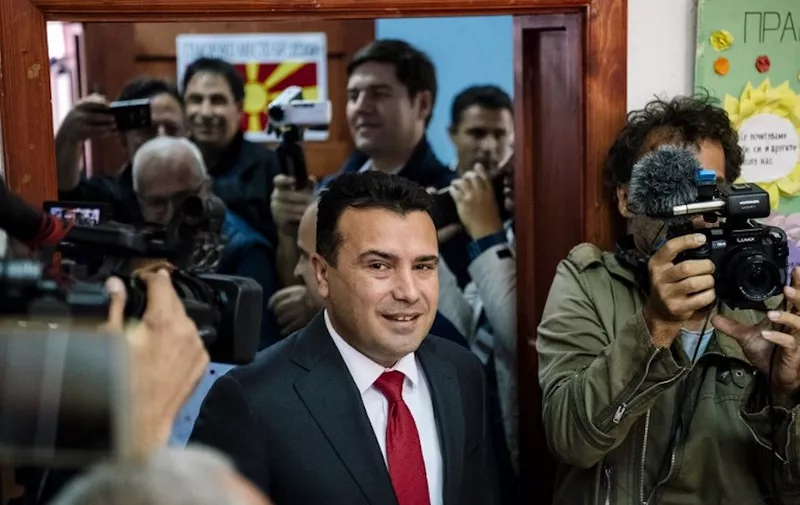 Macedonia's Prime Minister Zoran Zaev (C) arrives to vote in a polling station for a referendum to re-name their country North Macedonia in a bid to settle a long-running row with Greece and unlock its path to NATO and EU membership in Strumica on September 30, 2018. / AFP PHOTO / DIMITAR DILKOFF