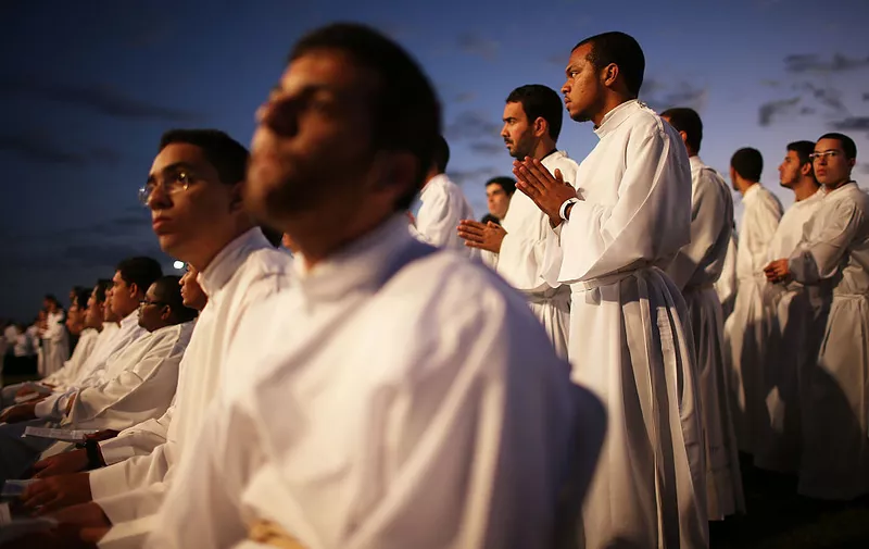 BRASILIA, BRAZIL - JUNE 04:  Catholic priests gather outside of the Cathedral of Brasilia while celebrating the holiday of Corpus Christi on June 4, 2015 in Brasilia, Brazil. The tradition is celebrated on the eight Thursday following Easter and commemorates the ritual of the Eucharist. Brazil holds the largest number of Roman Catholics on the planet and Pope Francis will be returning to Latin America next month for a three-country visit. The pontiff's first foreign trip was to Brazil.  (Photo by Mario Tama/Getty Images)
