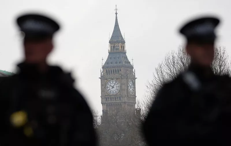 Armed police officers secure the area near the Houses of Parliament in central London on March 23, 2017 the day after the March 22 terror attack in Westminster claimed at least three lives including that of police officer Keith Palmer. 
Britain's parliament reopened on Thursday with a minute's silence in a gesture of defiance a day after an attacker sowed terror in the heart of Westminster, killing three people before being shot dead. Sombre-looking lawmakers in a packed House of Commons chamber bowed their heads and police officers also marked the silence standing outside the headquarters of London's Metropolitan Police nearby.
 / AFP PHOTO / Daniel LEAL-OLIVAS