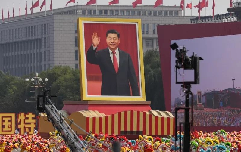 A float with a giant portrait of Chinese President Xi Jinping passes by Tiananmen Square during the National Day parade in Tiananmen Square in Beijing on October 1, 2019, to mark the 70th anniversary of the founding of the Peoples Republic of China. (Photo by Greg BAKER / AFP)