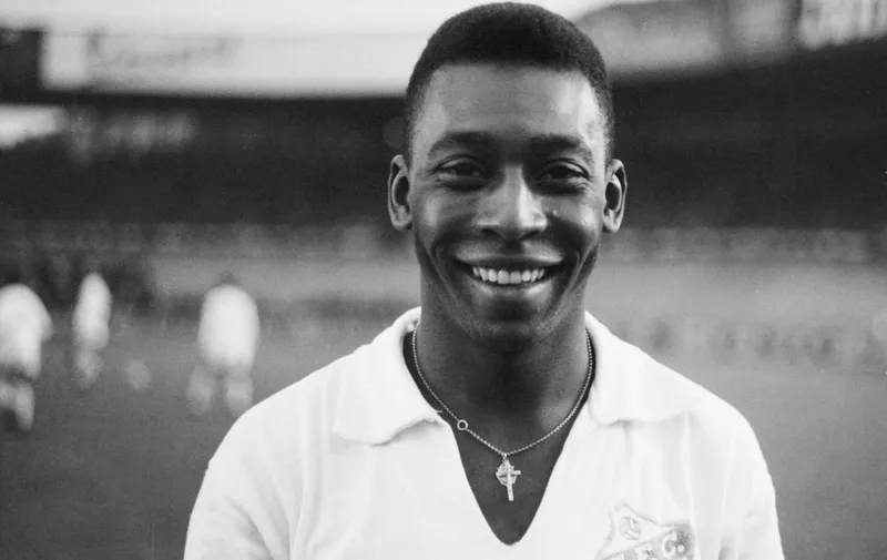 (FILES) In this file photo taken on June 13, 1961 Brazilian striker Pelé, wearing his Santos jersey, smiles before playing a friendly soccer match with his club against the French club of "Racing", in Colombes, in the suburbs of Paris. - Brazilian football icon Pele, widely regarded as the greatest player of all time and a three-time World Cup winner who masterminded the 'beautiful game', died on December 29, 2022 at the age of 82, after battling kidney problems and colon cancer. (Photo by AFP)