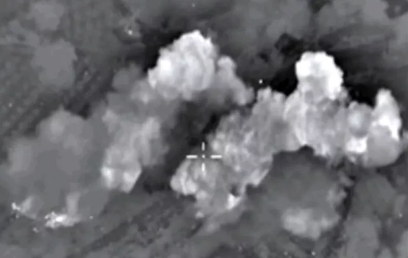 A video grab made on October 13, 2015, shows an image taken from a footage made available on the Russian Defence Ministry's official website, purporting to show explosions after airstrikes carried out by Russian air force on what Russia says was an Islamic State ammunition depot in the Syrian province of Hama. Russia's air force hit 86 "terrorist" targets in Syria in the past 24 hours, the defence ministry said on October 13, in the highest one-day tally since it launched its bombing campaign on September 30. AFP PHOTO / RUSSIAN DEFENCE MINISTRY 
*RESTRICTED TO EDITORIAL USE - MANDATORY CREDIT " AFP PHOTO / RUSSIAN DEFENCE MINISTRY" - NO MARKETING NO ADVERTISING CAMPAIGNS - DISTRIBUTED AS A SERVICE TO CLIENTS*