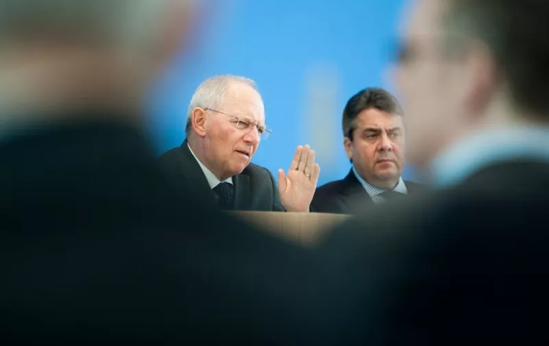 German Finance Minister Wolfgang Schaeuble (2nd L) and Vice Chancellor and Economic Minister Sigmar Gabriel (2nd R) attend a news conference at the Haus der Bundespressekonferenz in Berlin on March 18, 2015. Gabriel and Schaeuble commented the Federal budget plan for 2016 and the Financial Planning for 2019. AFP PHOTO / STEFFI LOOS