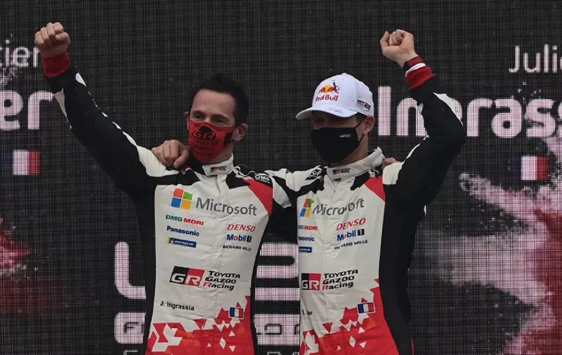 French driver Sebastien Ogier and his co-driver Julien Ingrassia celebrate on the podium after winning the FIA World Rally Championship at the Autodromo Nazionale circuit in Monza on December 6, 2020. - Ogier won ahead ahead of Estonian driver Ott Tanak and Spanish driver Dani Sordo. (Photo by MIGUEL MEDINA / AFP)