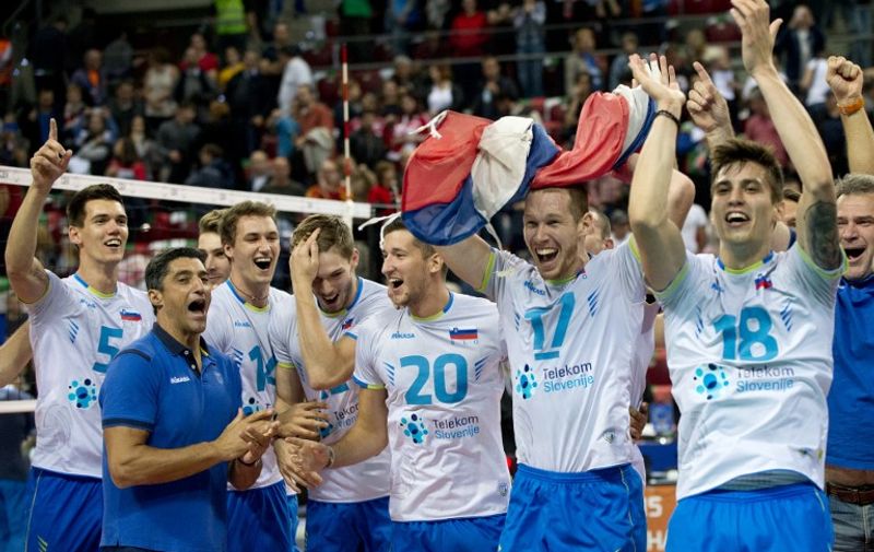 Slovenia's players celebrate after winning their European Volleyball Championships semi-final match against Italy in Sofia on October 17, 2015. AFP PHOTO / NIKOLAY DOYCHINOV