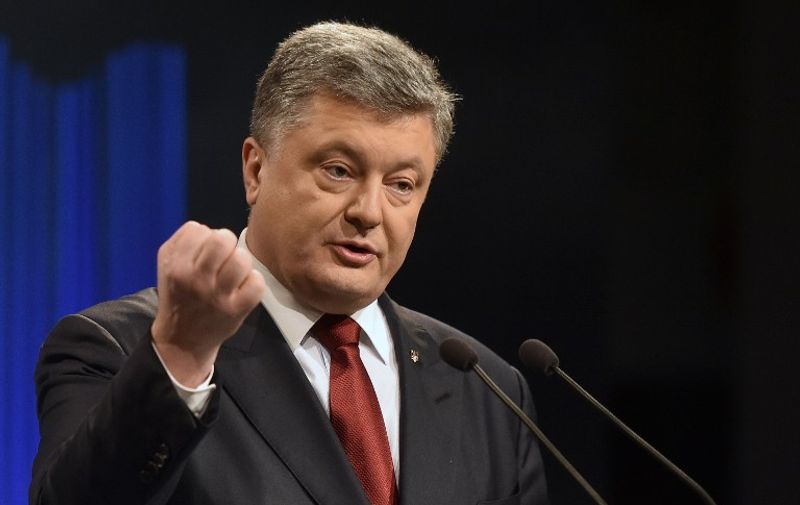 Ukrainian President Petro Poroshenko gestures during his press conference in Kiev on January 14, 2015. 
Ukrainian President Petro Poroshenko said he wanted EU and US help in securing Crimea's return from Russian control and vowed to regain sovereignty over the separatist east in 2016.  / AFP / GENYA SAVILOV