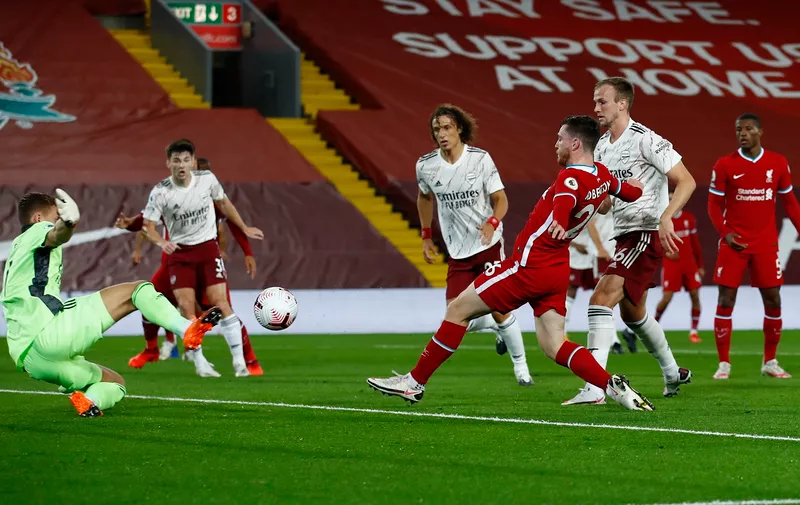 LIVERPOOL, ENGLAND - SEPTEMBER 28: Andy Robertson of Liverpool scores his sides second goal during the Premier League match between Liverpool and Arsenal at Anfield on September 28, 2020 in Liverpool, England. Sporting stadiums around the UK remain under strict restrictions due to the Coronavirus Pandemic as Government social distancing laws prohibit fans inside venues resulting in games being played behind closed doors. (Photo by Jason Cairnduff - Pool/Getty Images)