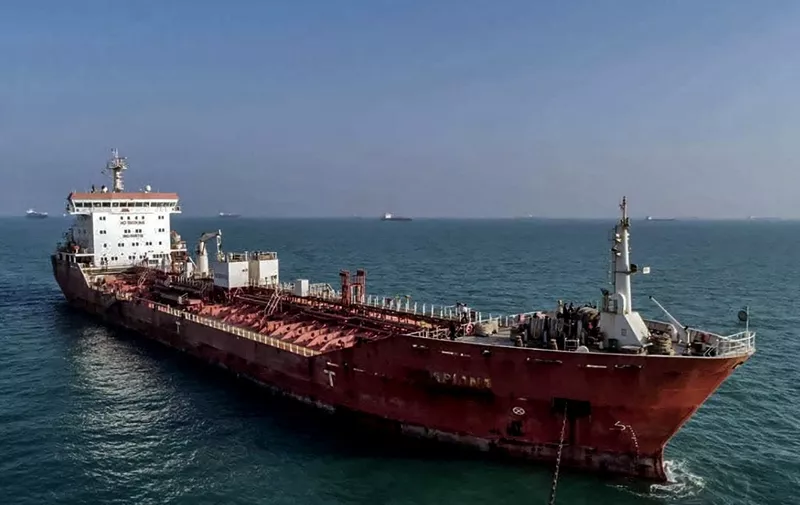 This picture taken on October 31, 2022 shows a view of an oil tanker, seized by Iranian naval forces at the Gulf port of Bandar Abbas in southern Iran. - Iran said the foreign-registered ship was smuggling fuel in the Gulf and arrested its crew, according to local media. "The navy of the Islamic Revolutionary Guard Corps has seized a foreign tanker carrying 11 million litres of smuggled fuel", said Mojtaba Ghahremani, the judiciary chief for Hormozgan province, according to the Tasnim news agency. It is not known when the vessel was seized, or what flag it sailed under. (Photo by IRNA / AFP)