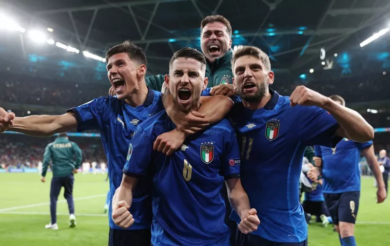Italy's midfielder Jorginho (C) celebrates with teammates after scoring in a penalty shootout and winning the UEFA EURO 2020 semi-final football match between Italy and Spain at Wembley Stadium in London on July 6, 2021. (Photo by Carl Recine / POOL / AFP)