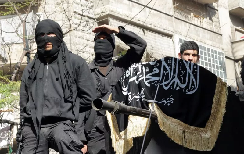 Members of jihadist group Al-Nusra Front take part in a parade calling for the establishment of an Islamic state in Syria, at the Bustan al-Qasr neighbourhood of Aleppo, on October 25, 2013. The conflict in Syria, which erupted after President Bashar al-Assad launched a bloody crackdown on Arab Spring-inspired democracy protests, is believed to have killed more than 115,000 people. AFP PHOTO / KARAM AL-MASRI / AFP / KARAM AL-MASRI