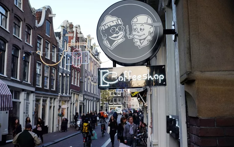 A picture taken on October 31, 2011 in center Amsterdam, shows the neon sign of a coffee shop.  Incensed by the "nuisance" caused by millions of people crossing its borders each year to visit one of 670 licensed coffee shops, the Netherlands plans to turn these cannabis-vending cafes into private clubs for card-carrying members -- Dutch residents only. The consumption and possession of small amounts of cannabis have been decriminalised since 1976 in the Netherlands. AFP PHOTO NATHALIE MAGNIEZ (Photo by NATHALIE MAGNIEZ / AFP)