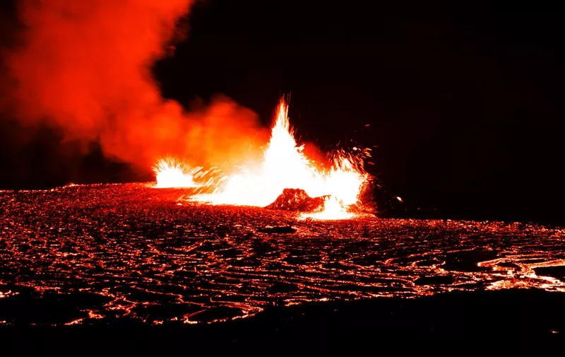 A photo taken on August 7, 2022 shows lava spewing out at the vulcano in Fagradalsfjall, Iceland, around 40 kilometres from the capital Reykjavik, following an eruption that has been ongoing since August 3, 2022. A volcano erupted in Iceland near the capital Reykjavik on August 3, the Icelandic Meteorological Office (IMO) said as live images on local media showed lava spewing out of a fissure in the ground. The eruption was some 40 kilometres (25 miles) from Reykjavik, near the site of the Mount Fagradalsfjall volcano that erupted for six months in March-September 2021, mesmerising tourists and spectators who flocked to the scene. (Photo by Jeremie RICHARD / AFP)