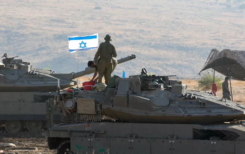 Israeli Merkava tanks are positioned in the north of Israel near the border with Lebanon on October 15, 2023. (Photo by Jalaa MAREY / AFP)