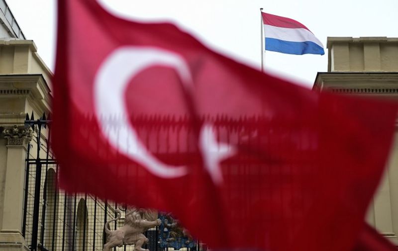 This picture taken on March 12, 2017, shows a Turkish national flag waved in front of the Dutch Consulate in Istanbul.
Protestors briefly took down the Dutch flag at the Dutch consulate in Istanbul and replaced it with a Turkish one, AFP journalists saw, as tensions escalated in a diplomatic row. Turkey's Family Minister Fatma Betul Sayan Kaya was back in Istanbul after being expelled from the Netherlands and escorted back to Germany by Dutch police, condemning The Hague's "ugly" treatment. / AFP PHOTO / YASIN AKGUL