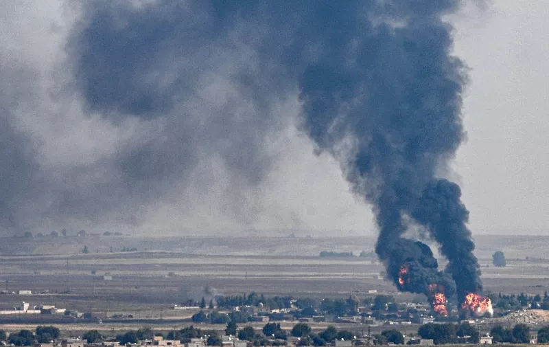 This picture taken on October 17, 2019 from the Turkish side of the border with Syria in the Ceylanpinar district city of Sanliurfa shows smoke and fire rising from the Syrian town of Ras al-Ain during the Turkish offensive against Kurdish groups in northeastern Syria. - Turkish troops and their Syrian proxies gained ground today in Ras al-Ain, a key border town where Kurdish fighters had been putting up stiff resistance, a war monitor said, as Kurdish authorities in northeastern Syria accused Turkey of resorting to banned weapons such as napalm and white phosphorus munitions. (Photo by Ozan KOSE / AFP)