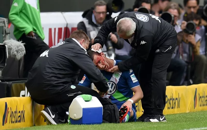 Injured Wolfsburg's Croatian midfielder Ivan Perisic receives treatment on the sideline during the German first division Bundesliga football match between Borussia Moenchengladbach and VfL Wolfsburg at the Borussia Park Stadium in Moenchengladbach, western Germany on April 26, 2015. AFP PHOTO /  PATRIK STOLLARZ

RESTRICTIONS - DFL RULES TO LIMIT THE ONLINE USAGE DURING MATCH TIME TO 15 PICTURES PER MATCH. IMAGE SEQUENCES TO SIMULATE VIDEO IS NOT ALLOWED AT ANY TIME. FOR FURTHER QUERIES PLEASE CONTACT DFL DIRECTLY AT + 49 69 650050.