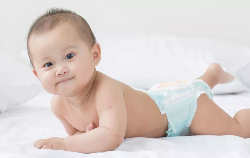 Young Asian baby climbing on the bed, Image: 421299118, License: Royalty-free, Restrictions: , Model Release: yes, Credit line: Profimedia, Depositphotos Inc.