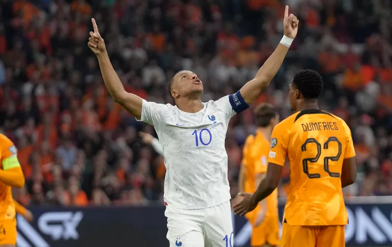 France's Kylian Mbappe, centre, celebrates after scoring his side's opening goal during the Euro 2024 group B qualifying soccer match between The Netherlands and France at the Johan Cruyff ArenA stadium in Amsterdam, Netherlands, Friday, Oct. 13, 2023. (AP Photo/Peter Dejong)