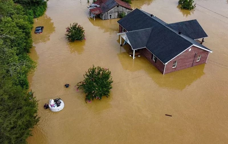 Aerial view of homes submerged under flood waters from the North Fork of the Kentucky River in Jackson, Kentucky, on July 28, 2022. - At least eight people have died after torrential rains caused massive flooding in eastern Kentucky, leaving a number of people stranded on rooftops and in trees, the governor of the southeastern US state said Thursday. (Photo by LEANDRO LOZADA / AFP)