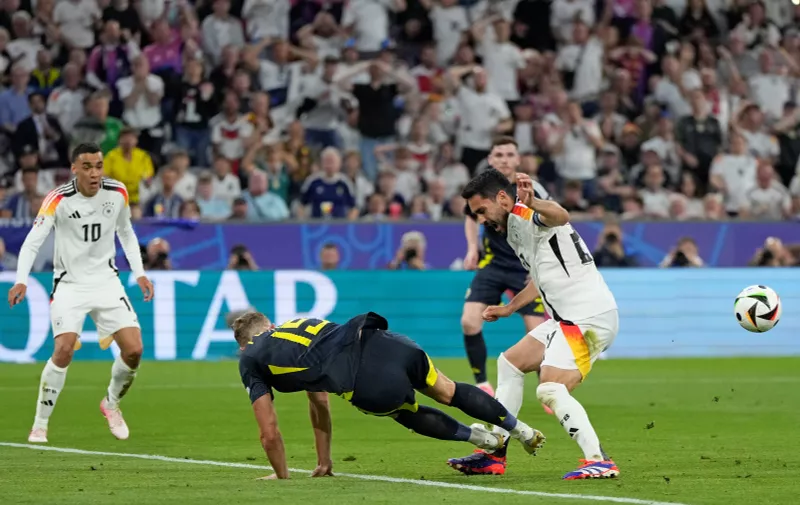 Scotland's Ryan Porteous, center left, fouls Germany's Ilkay Gundogan to give away a penalty during a Group A match between Germany and Scotland at the Euro 2024 soccer tournament in Munich, Germany, Friday, June 14, 2024. (AP Photo/Matthias Schrader)