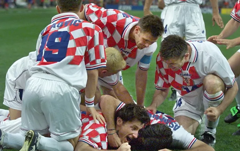 Croatian forward Davor Suker (C on ground) jubilates with teammates after scoring a goal for his team, 08 July during the Soccer World Cup semi-final match France vs Croatia at the Stade de France in Saint-Denis, north of Paris. (ELECTRONIC IMAGE) AFP PHOTO OMAR TORRES / AFP / OMAR TORRES