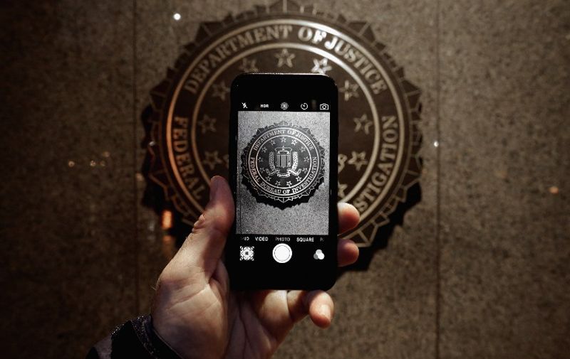 WASHINGTON, DC - FEBRUARY 23: The official seal of the Federal Bureau of Investigation is seen on an iPhone's camera screen outside the J. Edgar Hoover headquarters February 23, 2016 in Washington, DC. Last week a federal judge ordered Apple to write software that would allow law enforcement agencies investigating the December 2, 2015 terrorist attack in San Bernardino, California, to hack into one of the attacker's iPhone. Apple is fighting the order, saying it would create a way for hackers, foreign governments, and other nefarious groups to invade its customers' privacy.   Chip Somodevilla/Getty Images/AFP