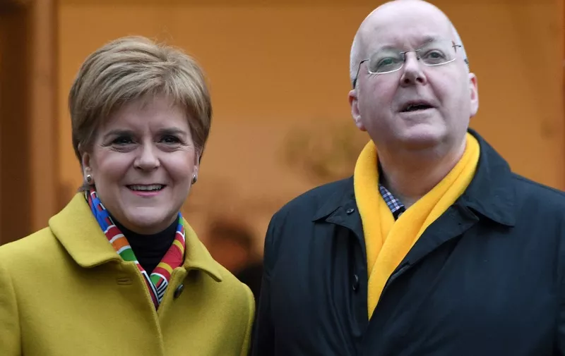 (FILES) In this file photo taken on December 12, 2019 Scotland's First Minister and leader of the Scottish National Party (SNP), Nicola Sturgeon, stands with her husband husband Peter Murrell as they stand outside a Polling Station where she arrived to cast her ballot paper and vote, in Glasgow, Scotland, as Britain holds a general election. - Peter Murrell, the husband of Scotland's former first minister Nicola Sturgeon, was arrested on April 5, 2023 as part of a police investigation into the finances of their Scottish National Party (SNP), UK media reported. Peter Murrell, 58, was the SNP's chief executive until he quit last month. (Photo by ANDY BUCHANAN / AFP)