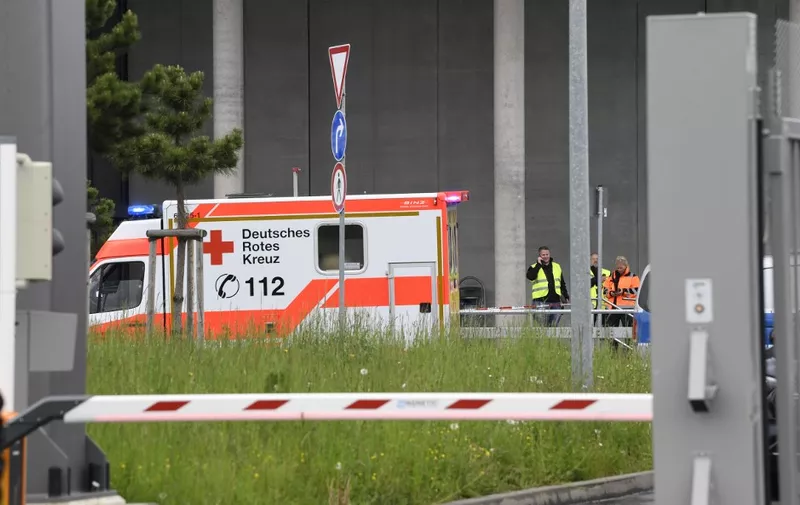 An ambulance car is seen in front of the Factory 56 at the plant of German car maker Mercedes-Benz in Sindelfingen, southern Germany, after shots were fired at the plant on May 11, 2023. One person was killed and another seriously injured at the factory, police said, adding that a suspect had been arrested. (Photo by Thomas KIENZLE / AFP)