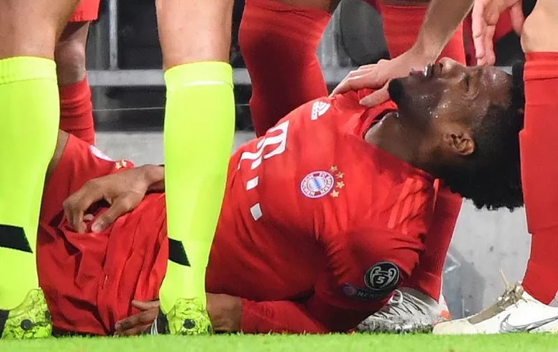 Bayern Munich's French forward Kingsley Coman receives medical care after being injured during the UEFA Champions League Group B football match between Bayern Munich and Tottenham FC on December 11, 2019 in Munich, Germany. (Photo by Peter Kneffel / dpa / AFP) / Germany OUT