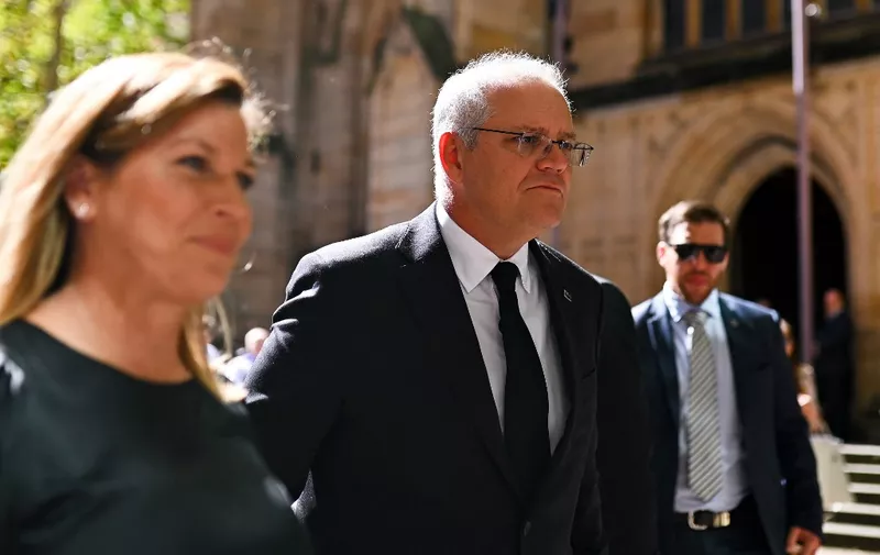 Australia's Prime Minister Scott Morrison (C) and wife Jenny Morrison (L) leave after attending a church service at St Andrews Cathedral in Sydney on April 11, 2021. (Photo by Steven Saphore / AFP)