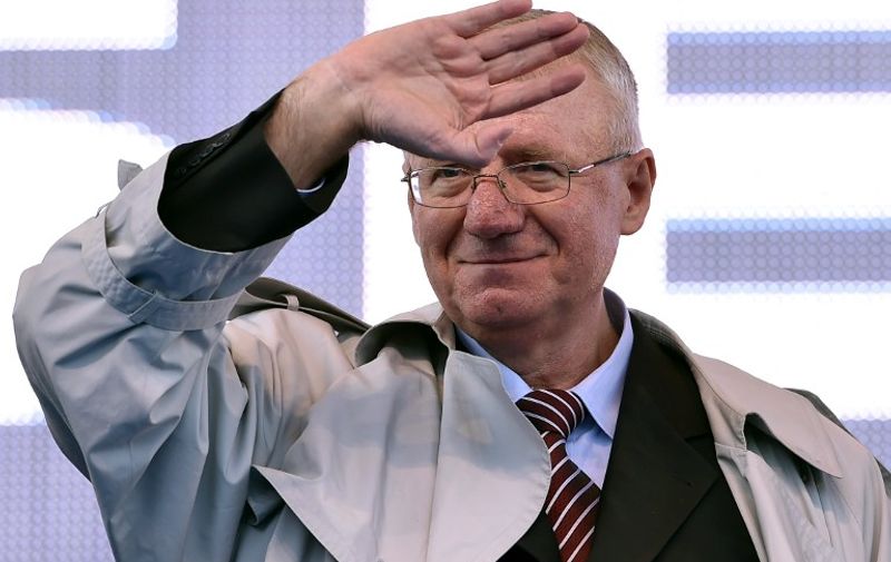 Serbian nationalist politician Vojislav Seselj waves to his supporters during an anti-government rally in Belgrade on November 15, 2014. Seselj is spearheading an anti-government rally but as he fights cancer and awaits judgement on war crimes charges, he is as beleaguered as his once formidable party. AFP PHOTO / ANDREJ ISAKOVIC / AFP / ANDREJ ISAKOVIC