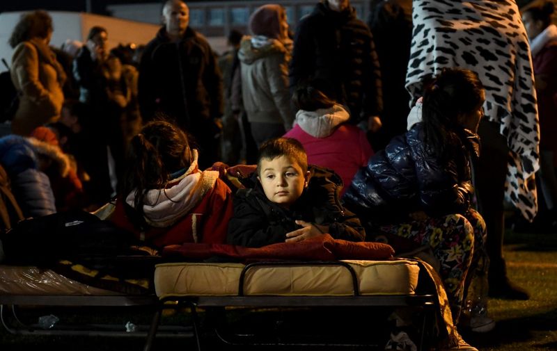 A boy lies in a portable bed in a camp at the soccer stadium in Durres on November 26, 2019, after the strongest earthquake in decades claimed at least 20 lives, with victims trapped in the debris of toppled buildings. - Albanian rescuers dug through rubble as desperate survivors trapped in toppled buildings cried out for help on November 26, 2019, after the strongest earthquake in decades killed at least 16 people and left hundreds injured. The 6.4 magnitude quake struck before dawn at 3:54 am local time (0254 GMT), with an epicentre 34 kilometres (about 20 miles) northwest of the capital Tirana, according to the European-Mediterranean Seismological Centre. (Photo by Gent SHKULLAKU / AFP)